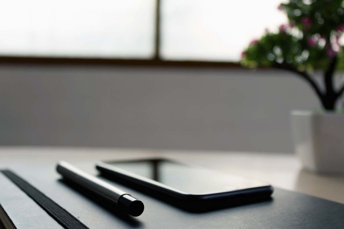 electronics mobile phone on wooden table grey